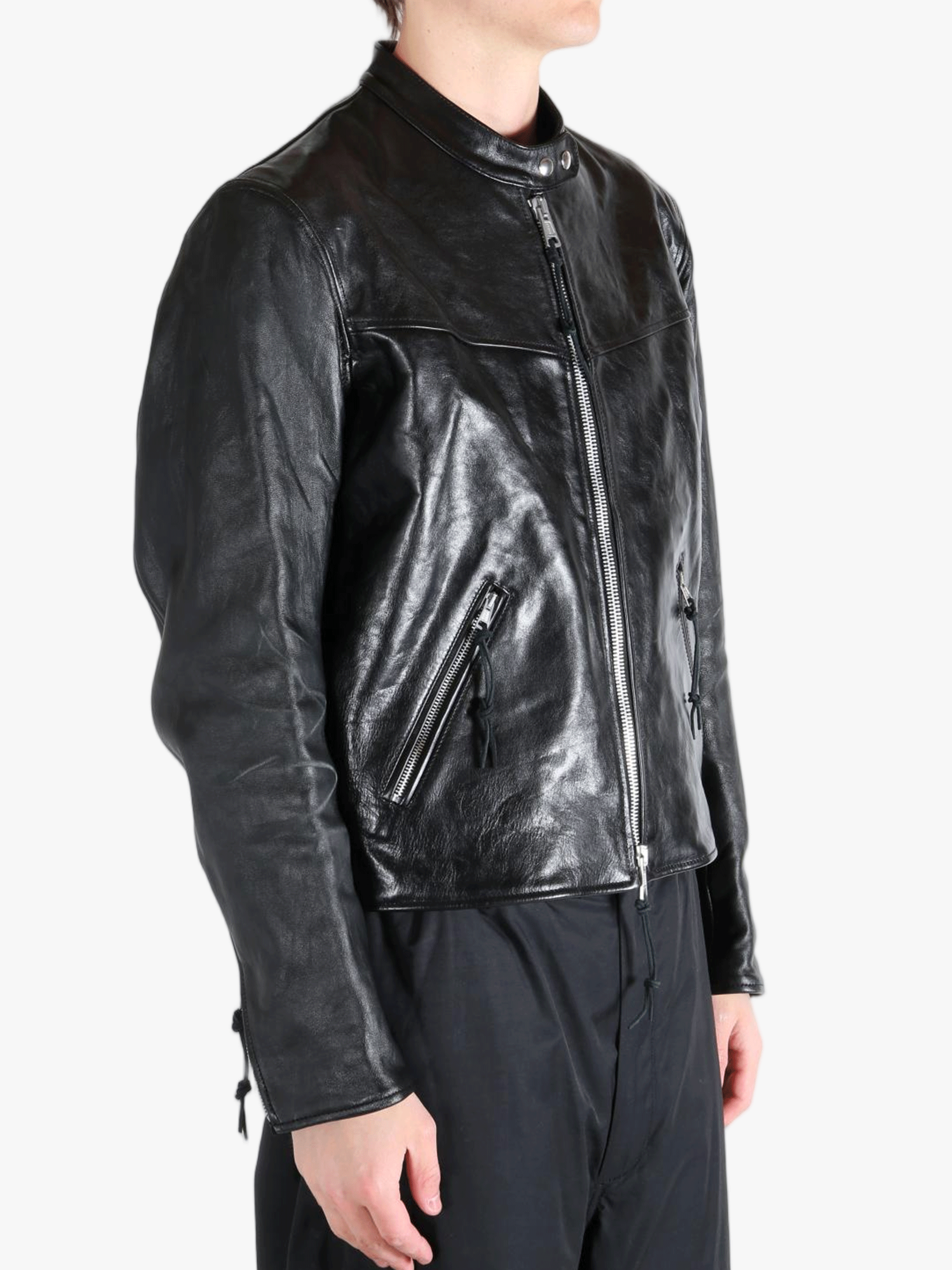 Black leather jacket worn by a person, showing the jacket fit