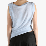 Blue vest worn by a person, showing the loose fit.