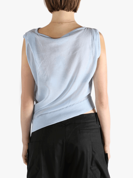 Blue vest worn by a person, showing the loose fit.