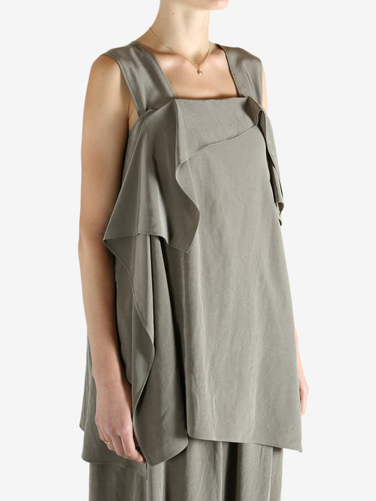 Grey tops worn by a person, showing the tops fit