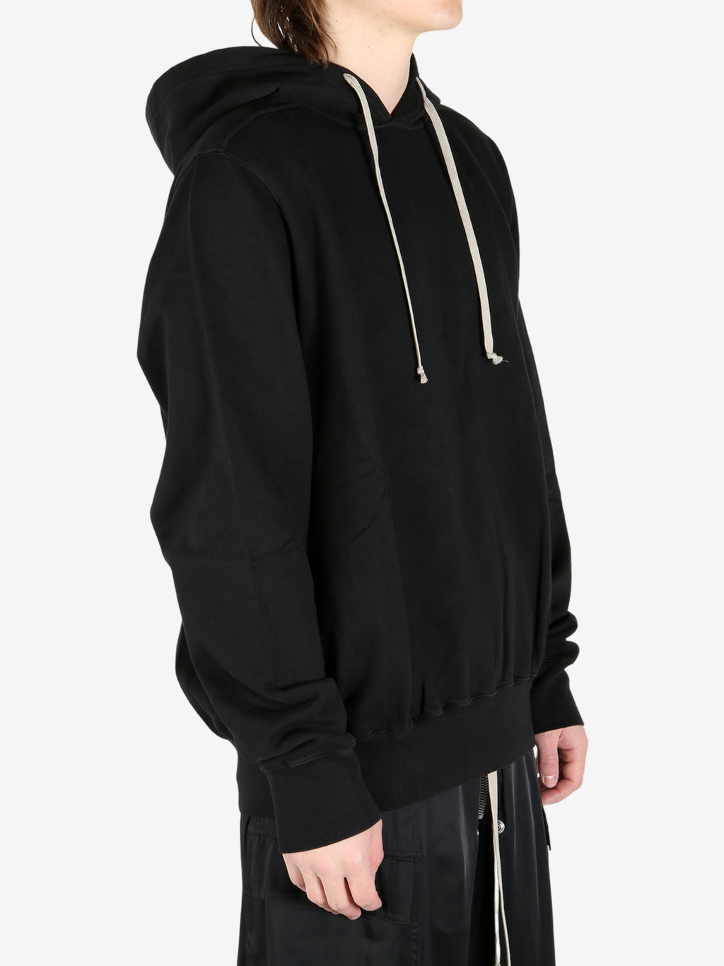 Black hoodie worn by a person, showing the hoodie's fit