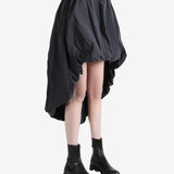 Grey skirts worn by a person, showing the skirts fit