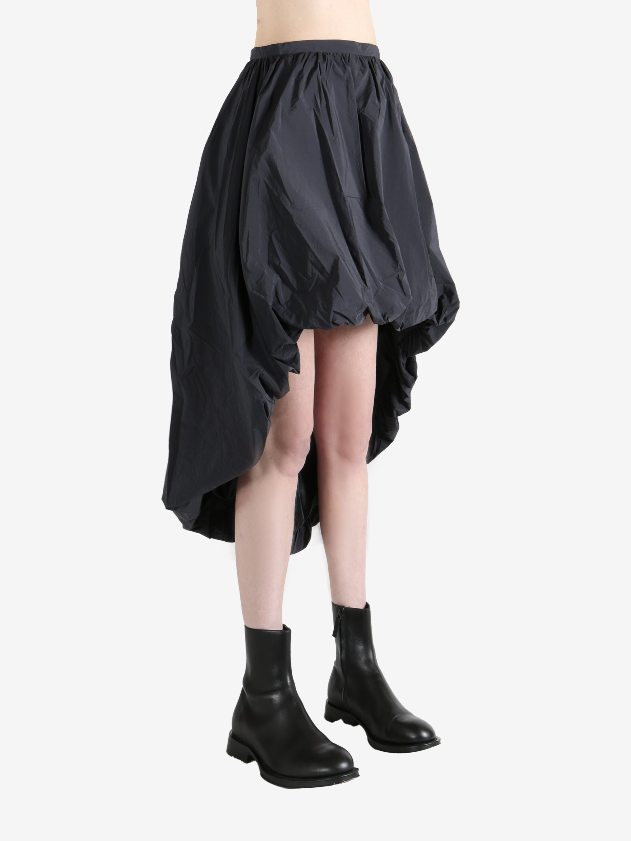 Grey skirts worn by a person, showing the skirts fit