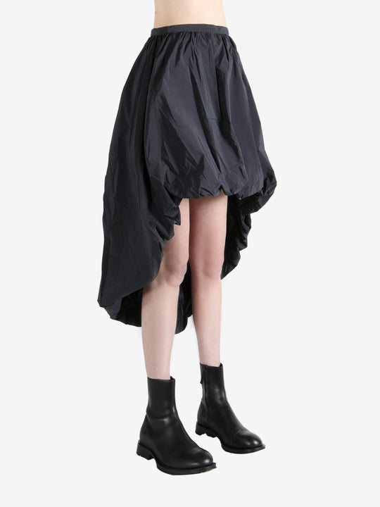 Grey skirts worn by a person, showing the skirts fit