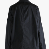 Black jacket worn by a person, showing the jacket fit