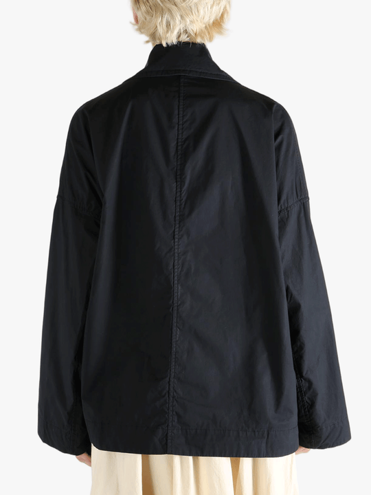 Black jacket worn by a person, showing the jacket fit