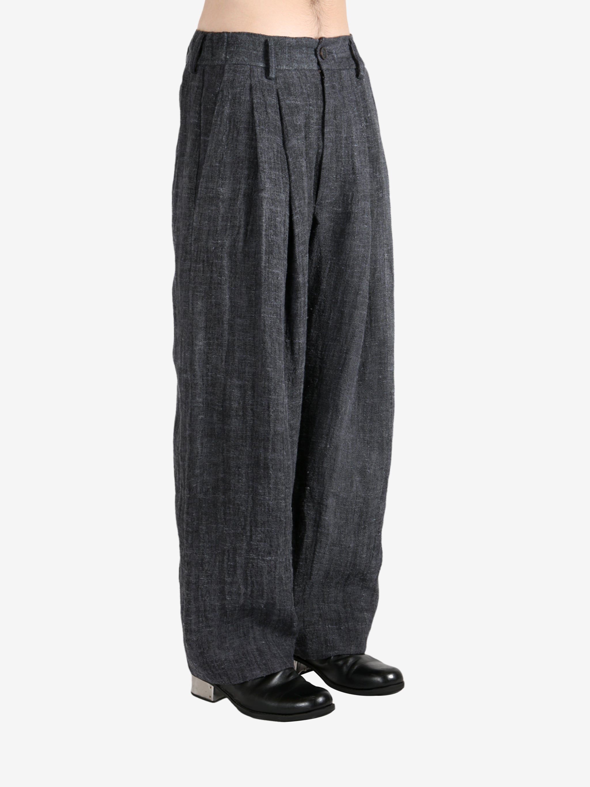 Black pants,worn by a person, showing the pants's fit