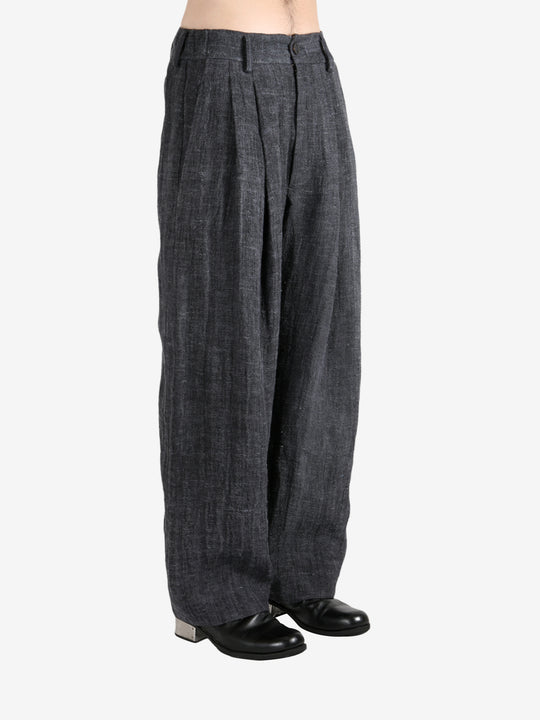 Black pants,worn by a person, showing the pants's fit