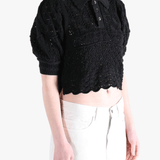 Black sweater worn by a person, showing the sweater fit