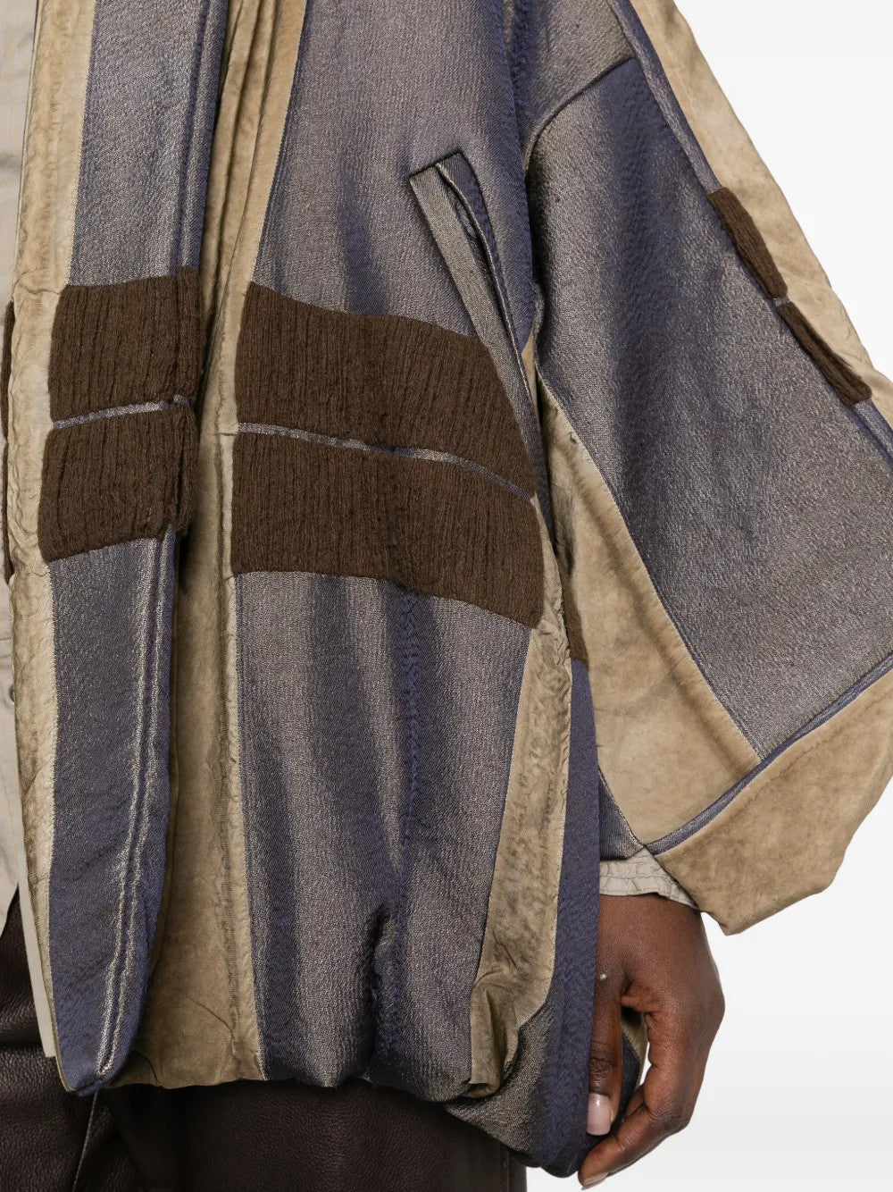 Close up of Tan jacket, showing texture of the 56% viscose/ 35% wool/ 9% polyamide fabric