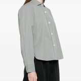 Gray button-up shirt worn by a person, showing the shirt's fit