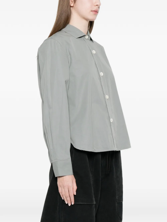 Gray button-up shirt worn by a person, showing the shirt's fit