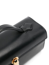 Close up of black bag, showing texture of the leather fabric
