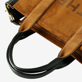 Close up of brown bag, showing texture of the leather fabric