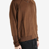 Brown cardigan worn by a person, showing the cardigan's fit