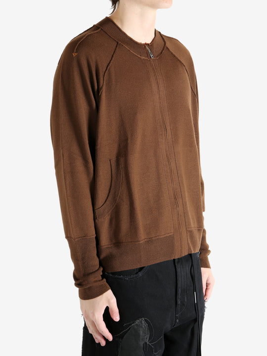 Brown cardigan worn by a person, showing the cardigan's fit