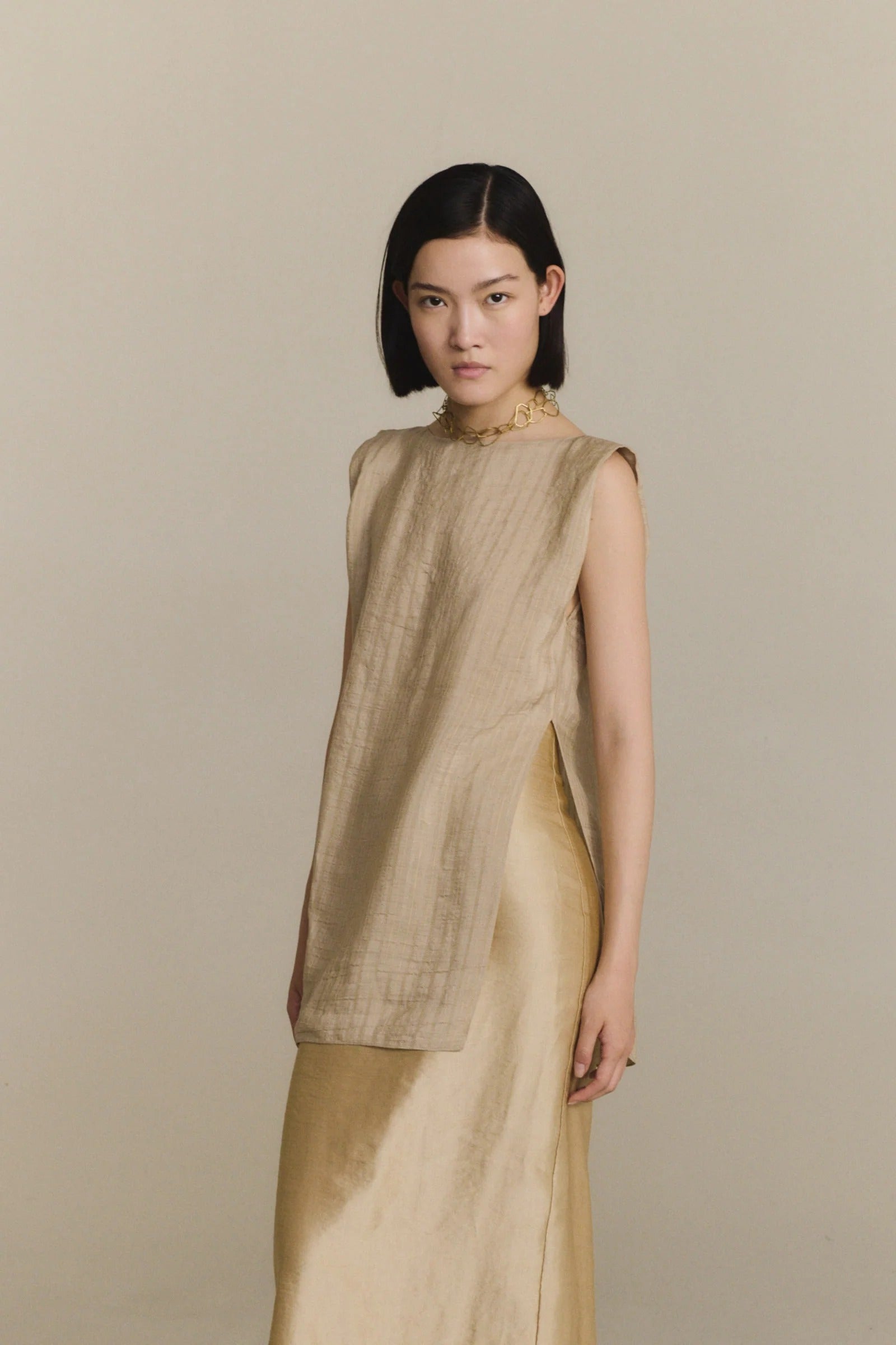 Tan top worn by a person, showing the top fit
