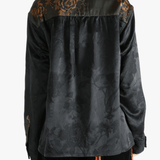 Black shirt worn by a person, showing the shirt's fit