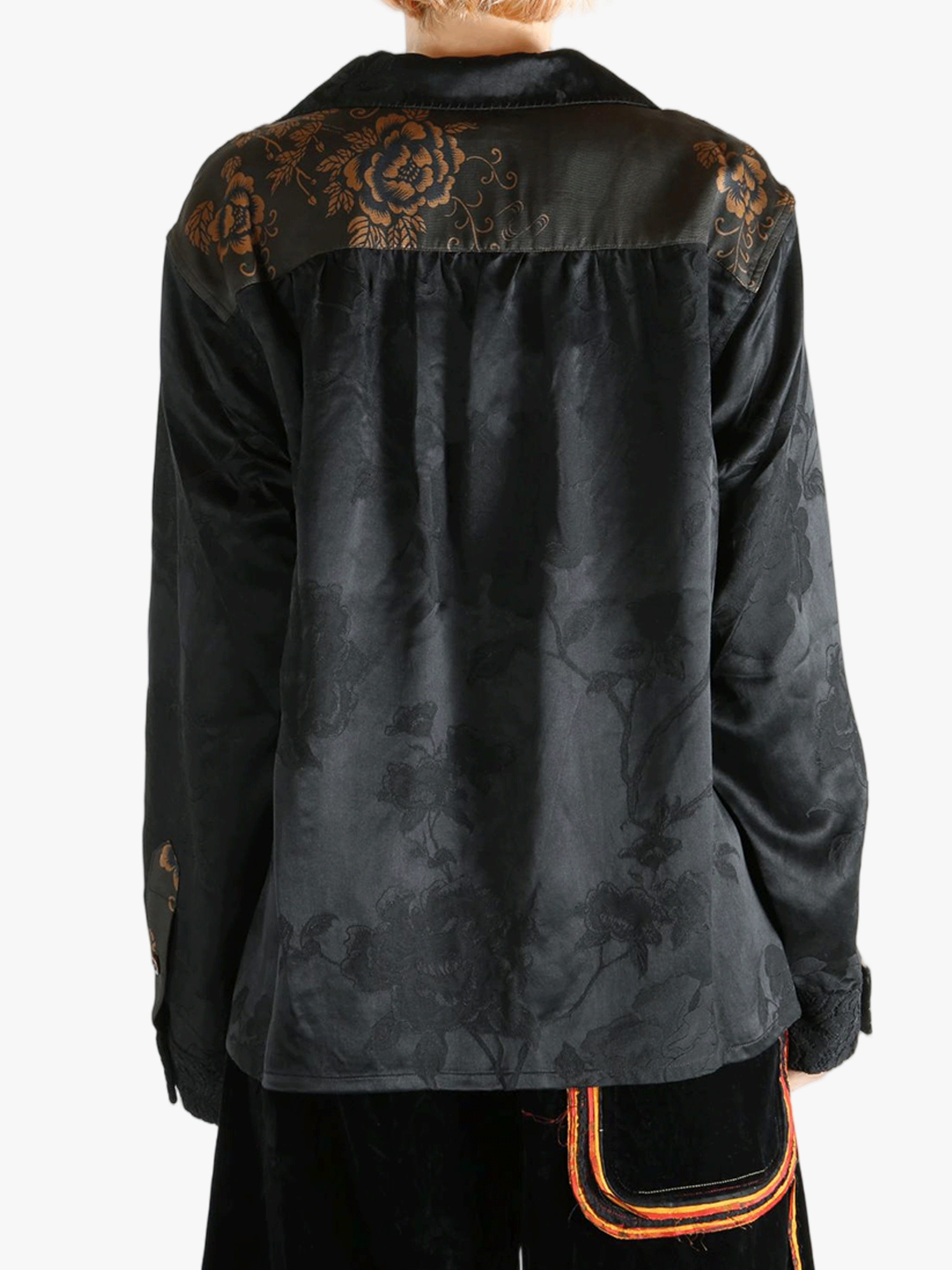 Black shirt worn by a person, showing the shirt's fit