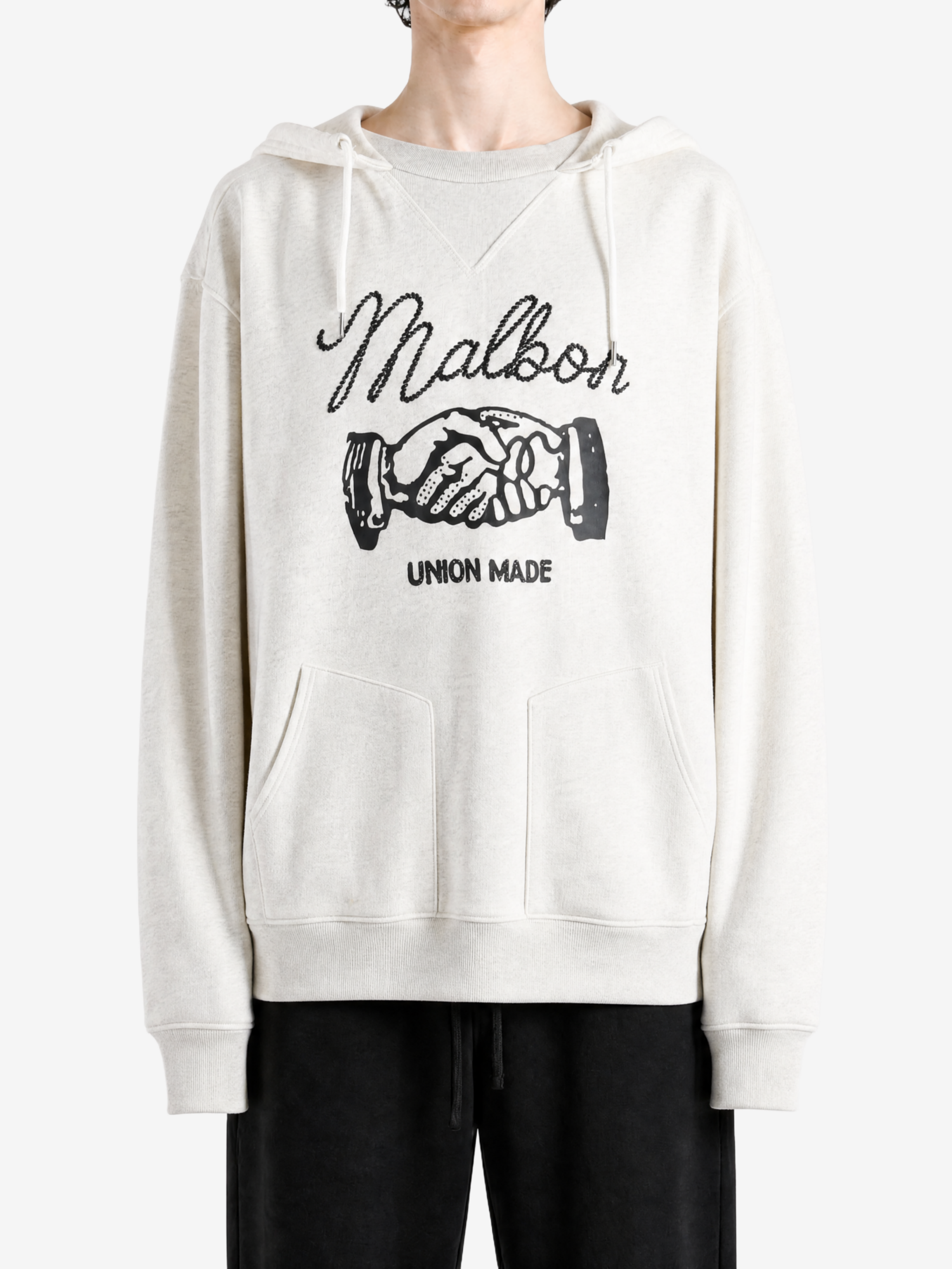 Tan hoodie worn by a person, showing the hoodie fit