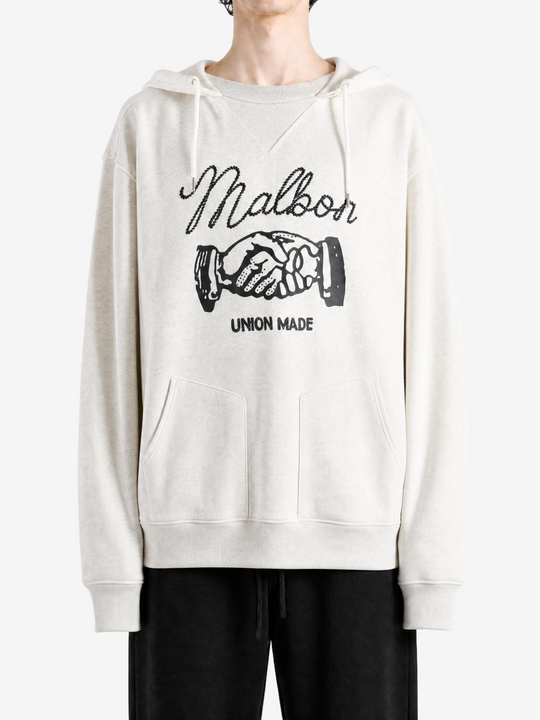 Tan hoodie worn by a person, showing the hoodie fit