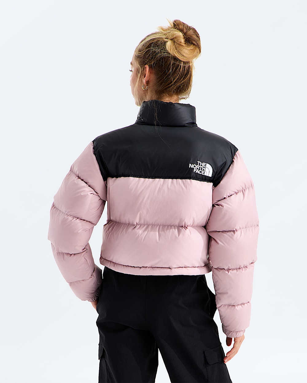 Pink jacket worn by a person, showing the jacket fit