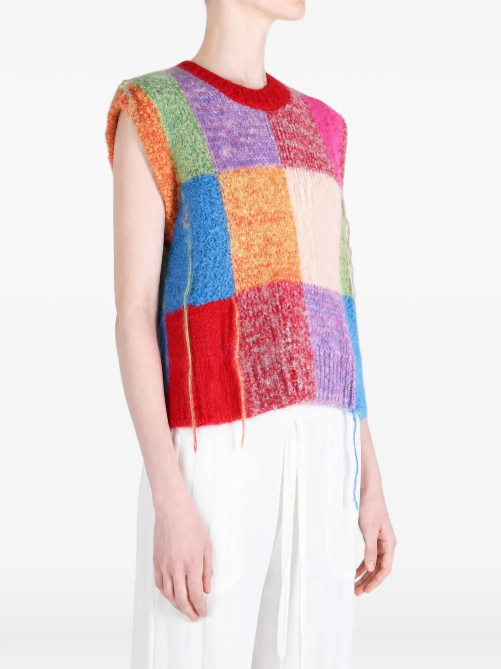 Red knitwear worn by a person, showing the knitwear fit