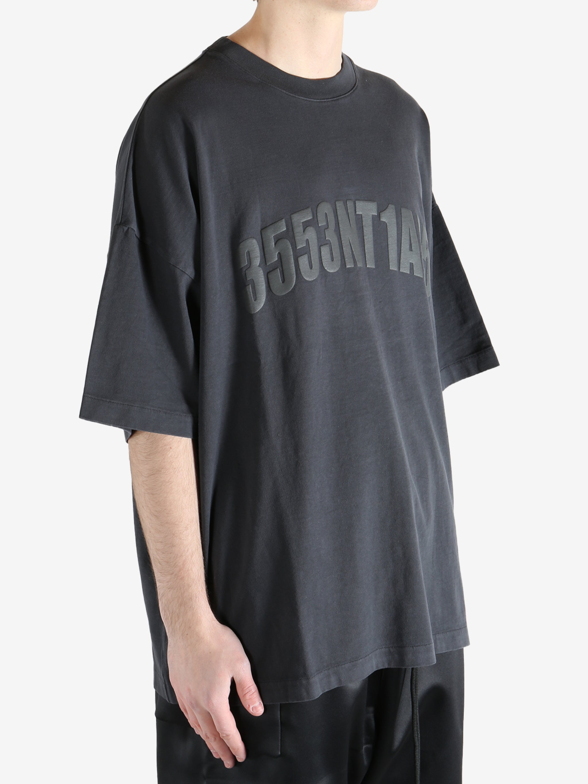 Black t-shirt worn by a person, showing the shirt's fit