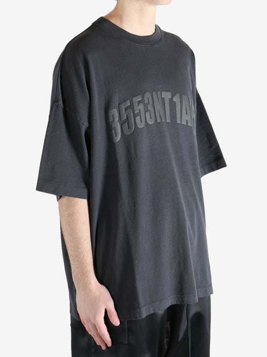 Black t-shirt worn by a person, showing the shirt's fit