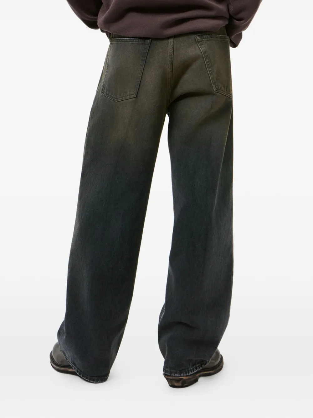 Grey pants, worn by a person, showing the t-shirt fit