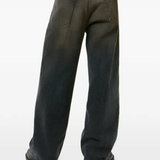 Grey pants, worn by a person, showing the t-shirt fit