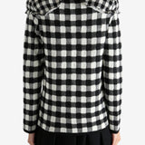 Black sweater worn by a person, showing the knitwear's fit