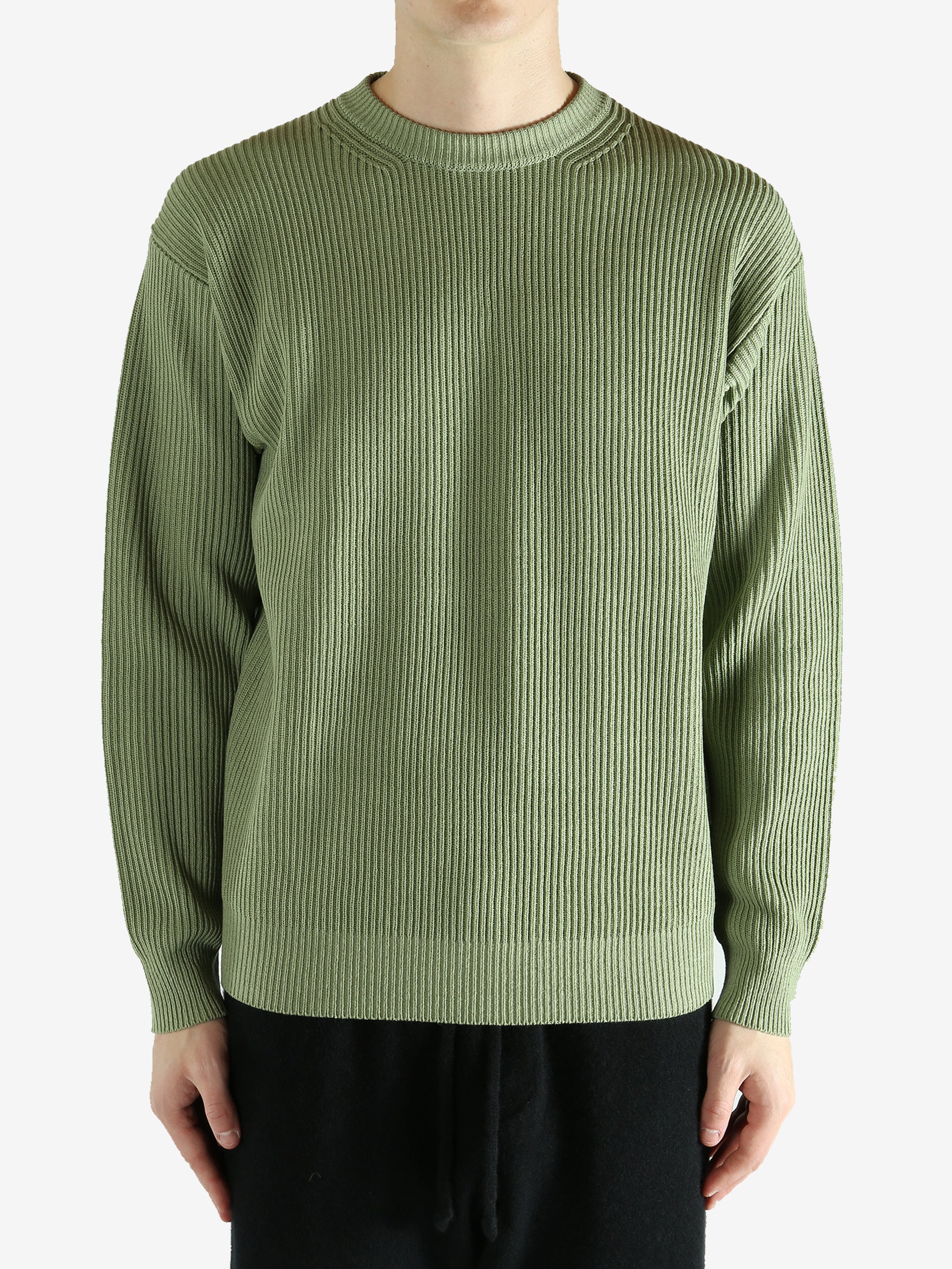 Green knitwear worn by a person, showing the knitwear's fit