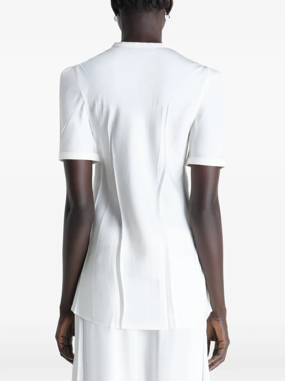White shirt worn by a person, showing the shirt's fit