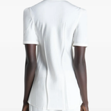 White shirt worn by a person, showing the shirt's fit