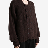 Brown knitwear worn by a person, showing the knitwear fit