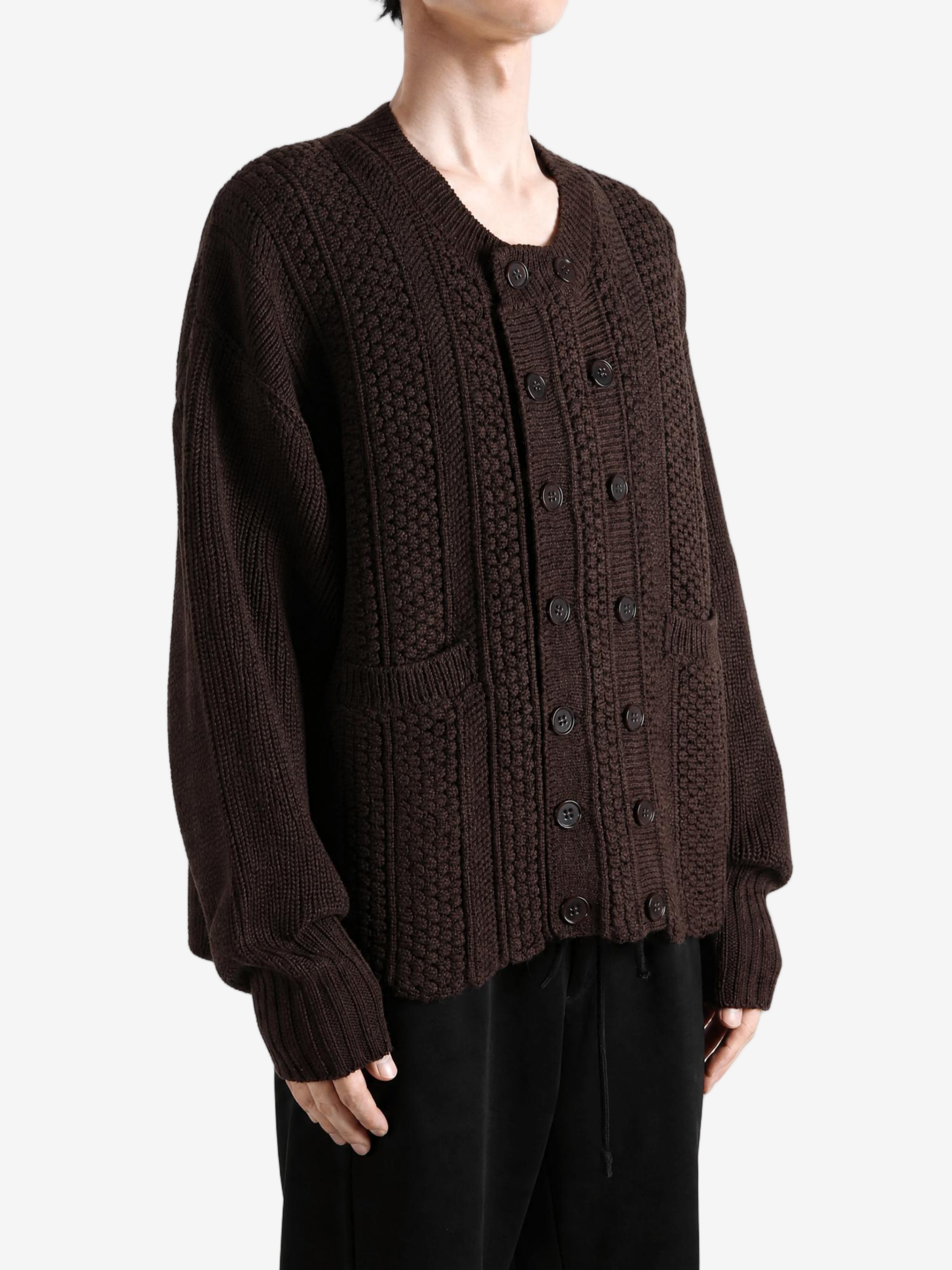 Brown knitwear worn by a person, showing the knitwear fit