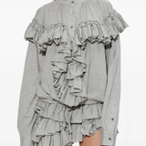 Grey top worn by a person, showing the top fit