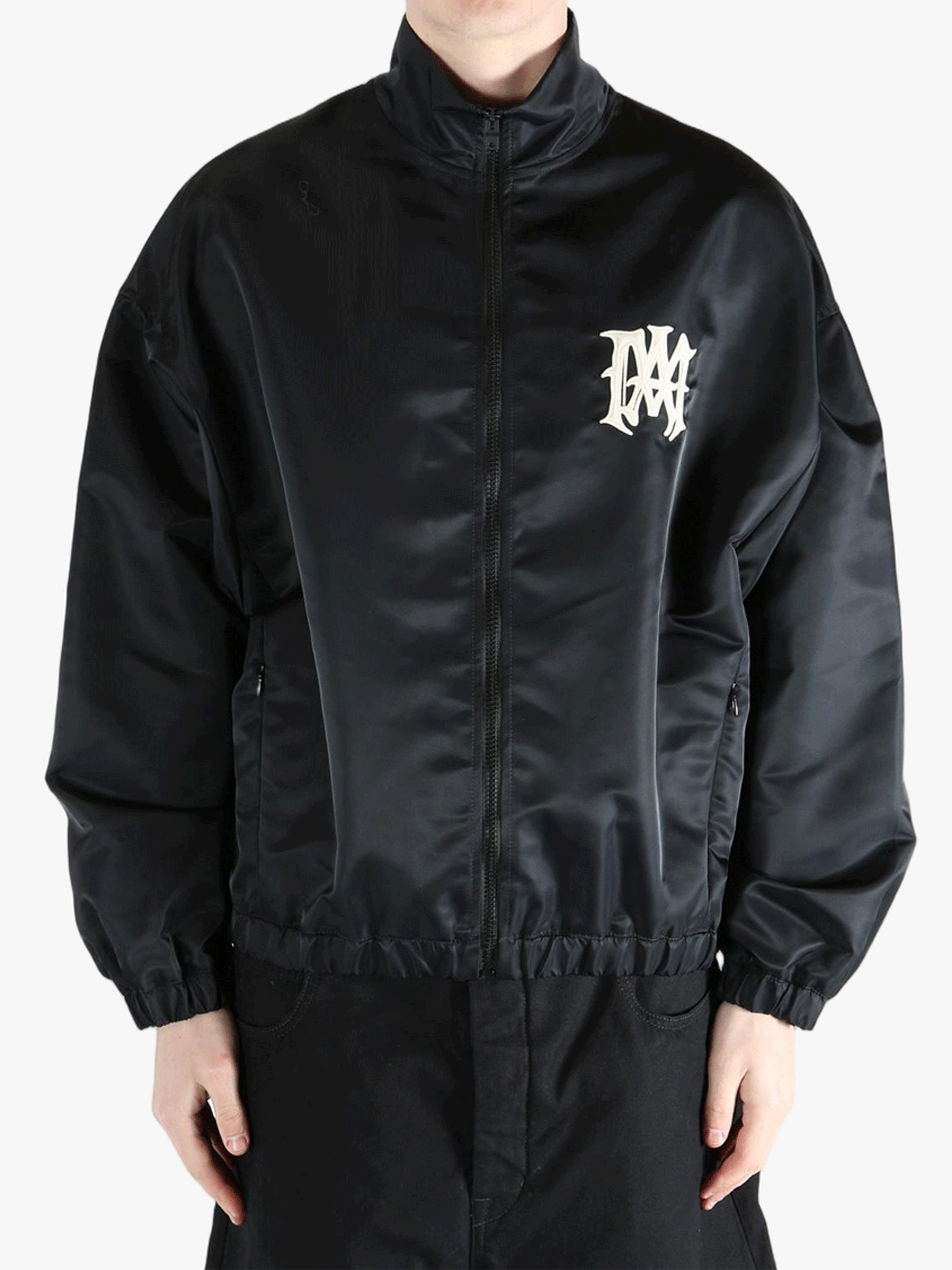 Black jacket worn by a person, showing the jacket's fit