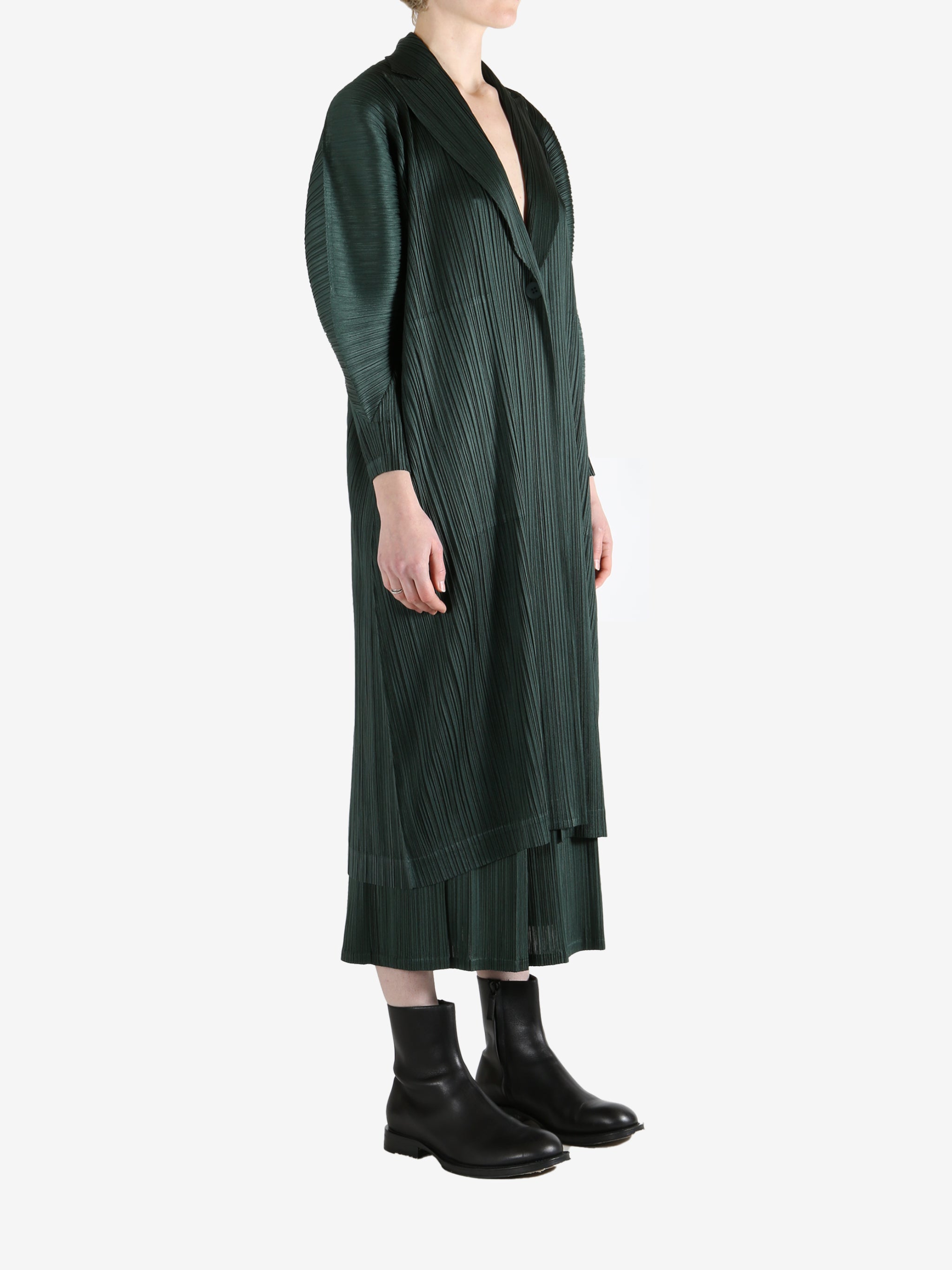 Green coat worn by a person, showing the coat's fit