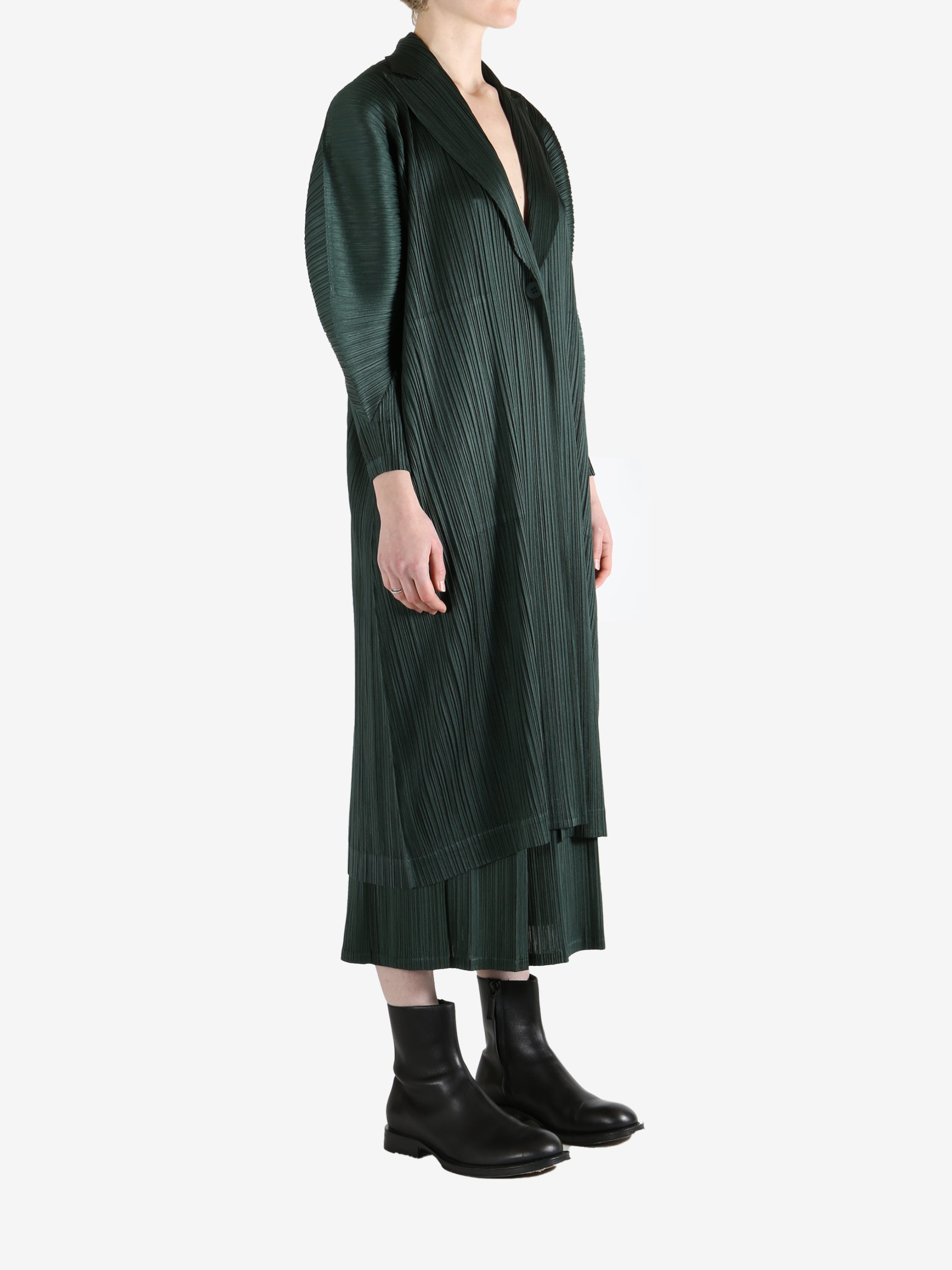 Green coat worn by a person, showing the coat's fit