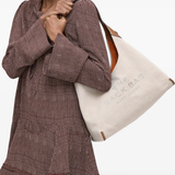 Tan bag worn by a person, showing the bags fit