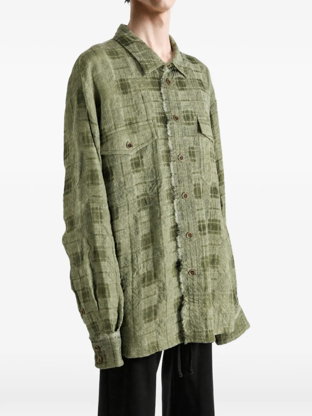 Green top worn by a person, showing the top fit
