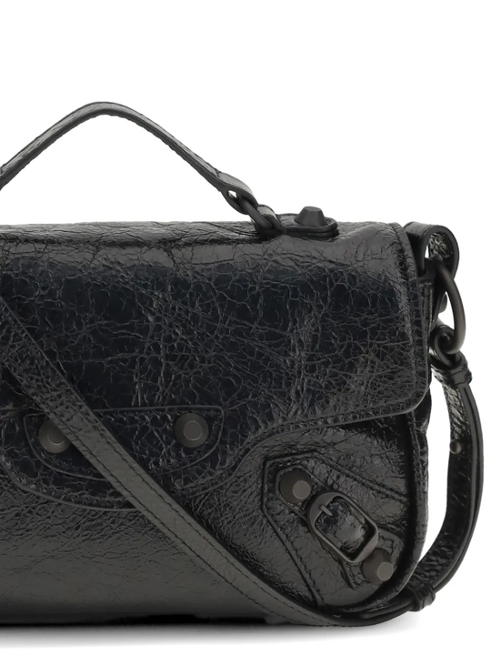 Close up of black bags , showing texture of the lamb skin fabric