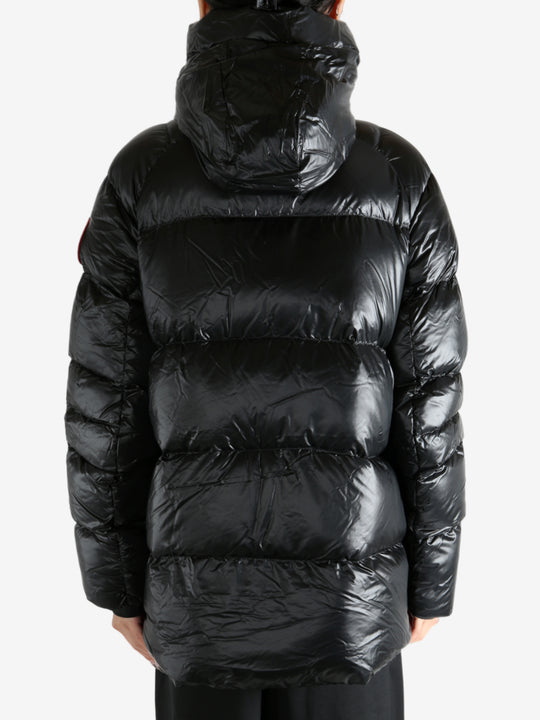 Black coat worn by a person, showing the coat's fit