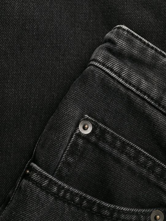 Close up of black pants, showing texture of the Denim fabric