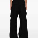 Black pants worn by a person, showing the pants' fit