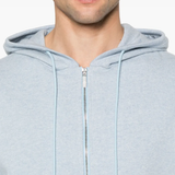 Close up of the blue hoodie, showing texture of the cotton fabric