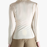 White top worn by a person,showing the top fit