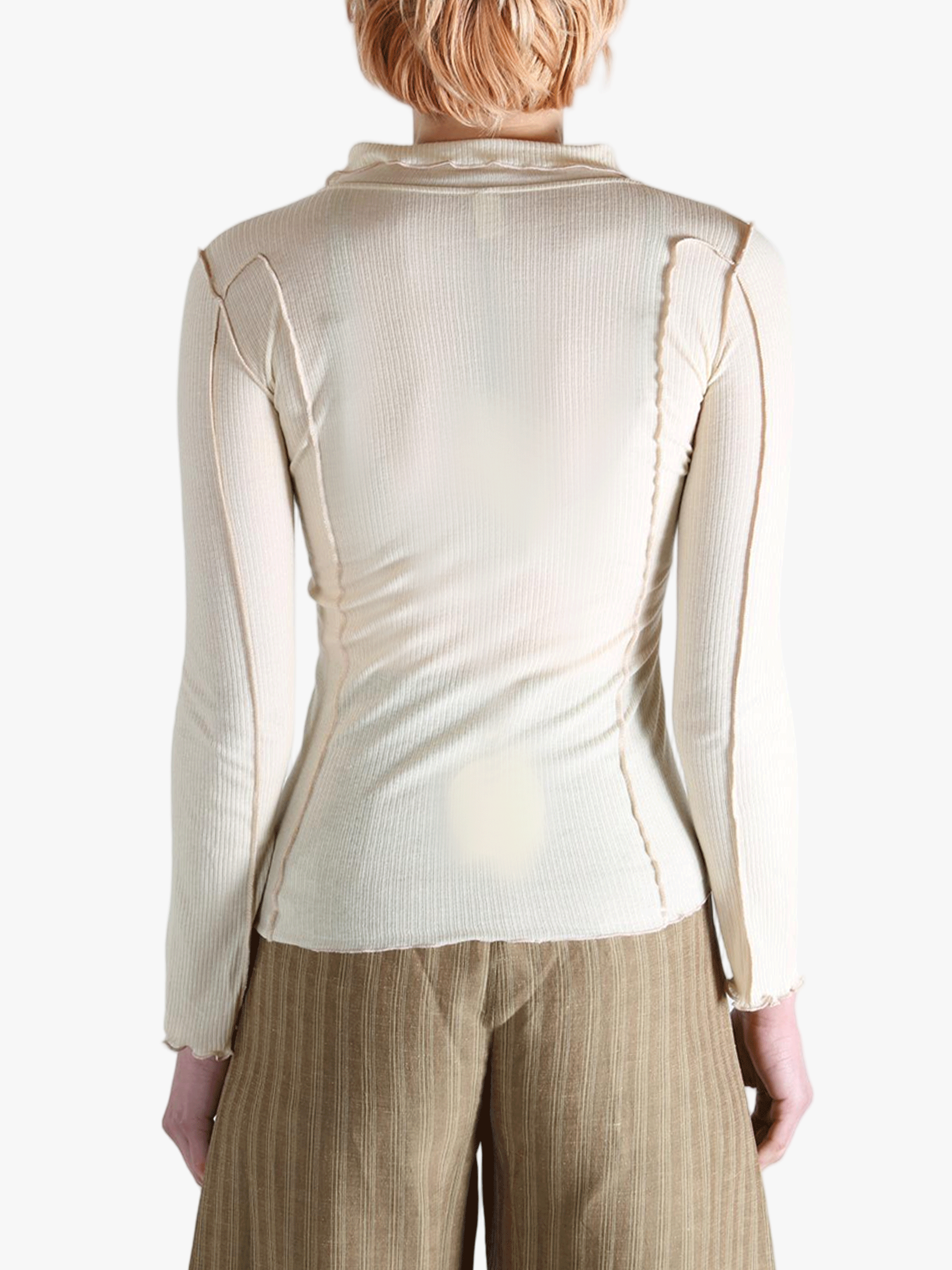 White top worn by a person,showing the top fit